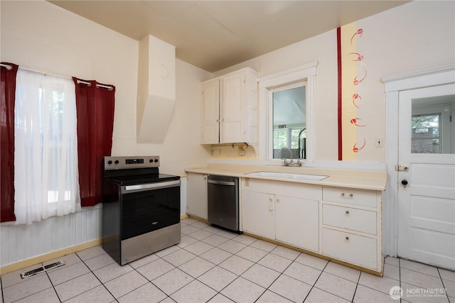 766 120th St S Unit A & B, Tacoma, WA 98444 - kitchen with appliances with stainless steel finishes, a sink, light countertops, and white cabinets