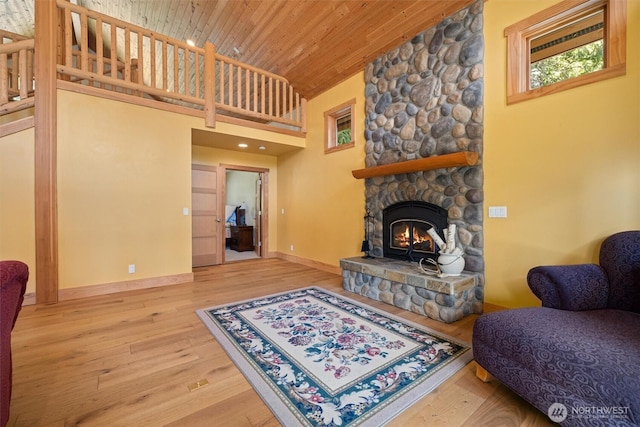 2677 Sumac Ln, Leavenworth, WA 98826 - living room featuring wood-type flooring, wood ceiling, high vaulted ceiling, baseboards, and a stone fireplace