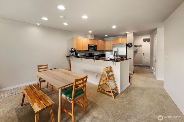 1000 Cabin Creek Ln SW Unit C204, Issaquah, WA 98027 - kitchen featuring stainless steel appliances, a peninsula, recessed lighting, light brown cabinets, and light colored carpet