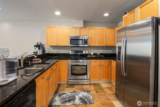 1000 Cabin Creek Ln SW Unit C204, Issaquah, WA 98027 - kitchen featuring appliances with stainless steel finishes, a sink, light stone finish floors, dark stone counters, and recessed lighting