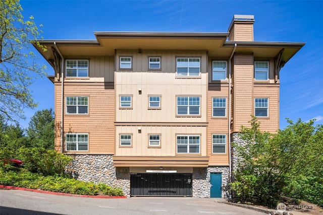 1000 Cabin Creek Ln SW Unit C204, Issaquah, WA 98027 - view of building exterior with an attached garage, driveway, and central AC