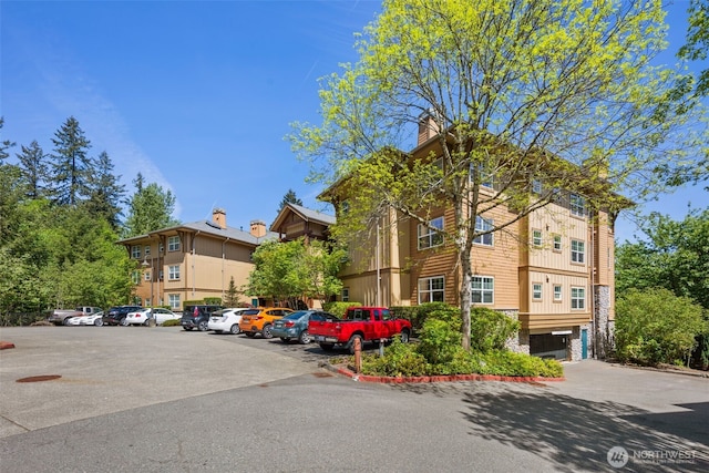1000 Cabin Creek Ln SW Unit C204, Issaquah, WA 98027 - view of building exterior with uncovered parking