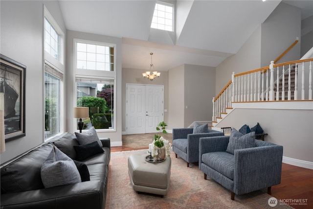 9702 S 230th Pl, Kent, WA 98031 - living area with a chandelier, stairs, high vaulted ceiling, wood finished floors, and baseboards