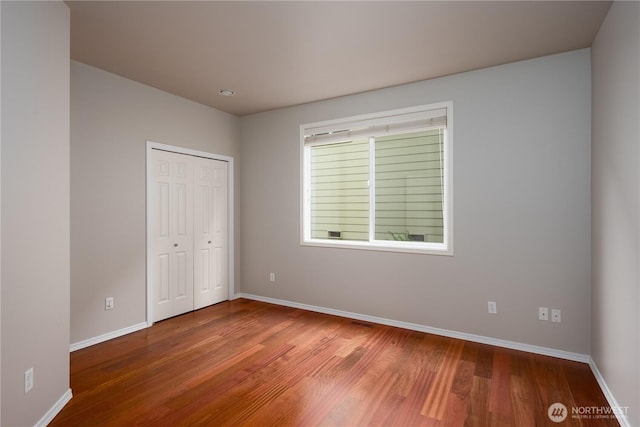 9702 S 230th Pl, Kent, WA 98031 - unfurnished bedroom with wood finished floors, baseboards, and a closet