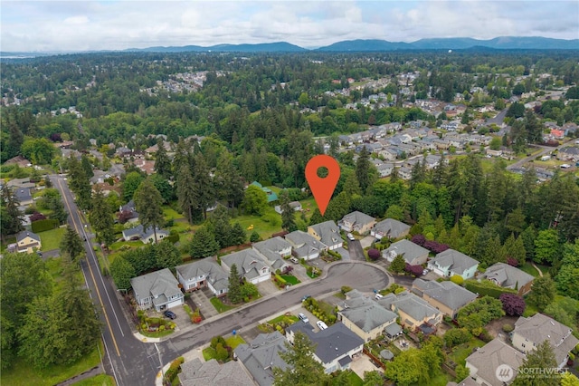 9702 S 230th Pl, Kent, WA 98031 - aerial view of property and surrounding area with nearby suburban area, mountains, and a heavily wooded area