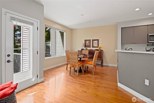 dining area with light wood-style floors, baseboards, and recessed lighting