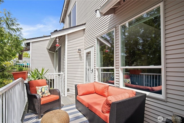 wooden deck with an outdoor living space