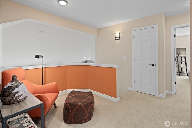sitting room with carpet and baseboards