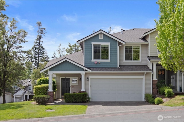 view of front of property with asphalt driveway, a shingled roof, a front yard, and an attached garage