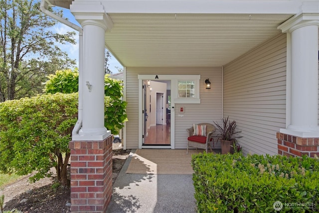view of exterior entry featuring a porch