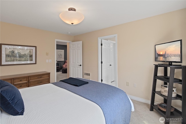 bedroom with light carpet and baseboards