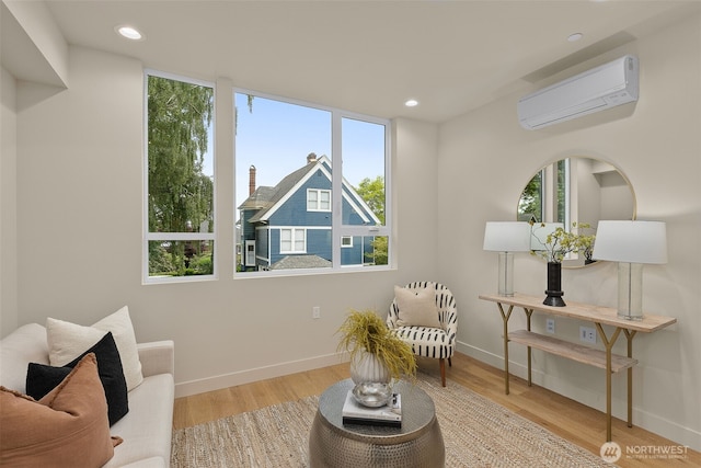 1106B 34th Ave, Seattle, WA 98122 - sitting room with a wall mounted AC, wood finished floors, recessed lighting, and baseboards