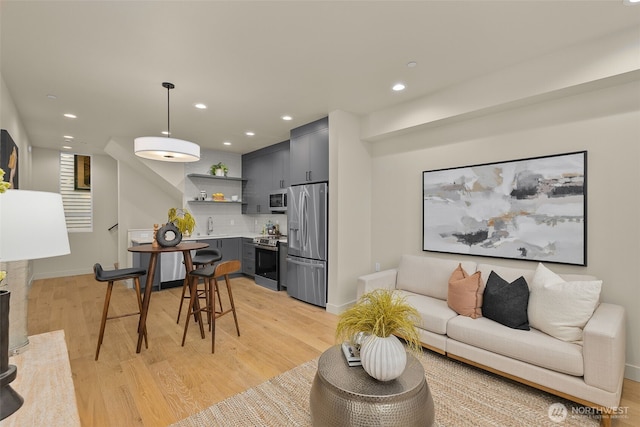 1106B 34th Ave, Seattle, WA 98122 - living room featuring light wood finished floors, baseboards, and recessed lighting