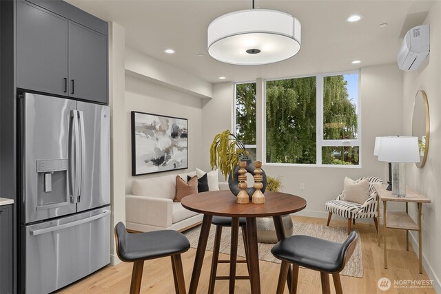 1106B 34th Ave, Seattle, WA 98122 - dining space with a wall mounted air conditioner, light wood finished floors, recessed lighting, and baseboards