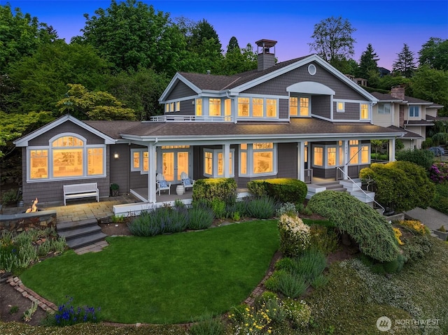 7934 Lake View Ln, Mercer Island, WA 98040 - rear view of property featuring a chimney, a yard, roof with shingles, a porch, and a balcony