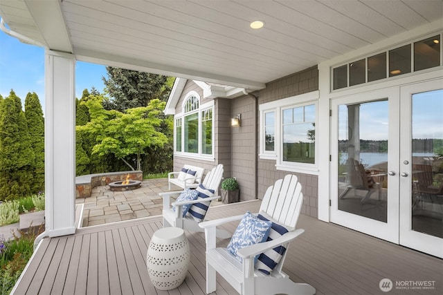 7934 Lake View Ln, Mercer Island, WA 98040 - wooden deck featuring a fire pit, french doors, a patio, and a water view