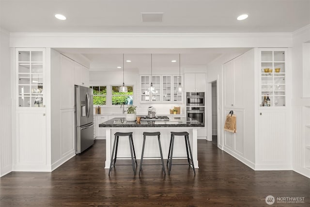 7934 Lake View Ln, Mercer Island, WA 98040 - kitchen with stainless steel appliances, a breakfast bar, white cabinets, recessed lighting, and ornamental molding
