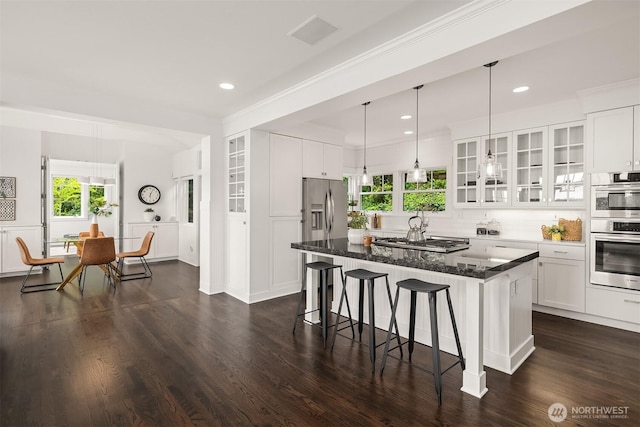 7934 Lake View Ln, Mercer Island, WA 98040 - kitchen featuring a breakfast bar, a kitchen island, white cabinetry, glass insert cabinets, and dark wood-type flooring