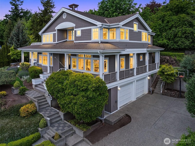 7934 Lake View Ln, Mercer Island, WA 98040 - view of front of house featuring stairs, covered porch, an attached garage, asphalt driveway, and a shingled roof