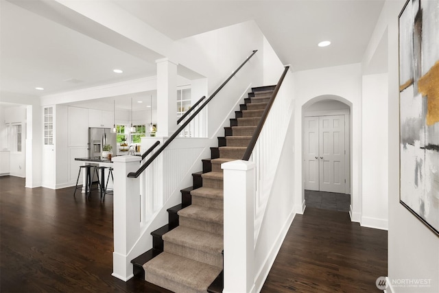 7934 Lake View Ln, Mercer Island, WA 98040 - staircase with wood finished floors, arched walkways, baseboards, and recessed lighting