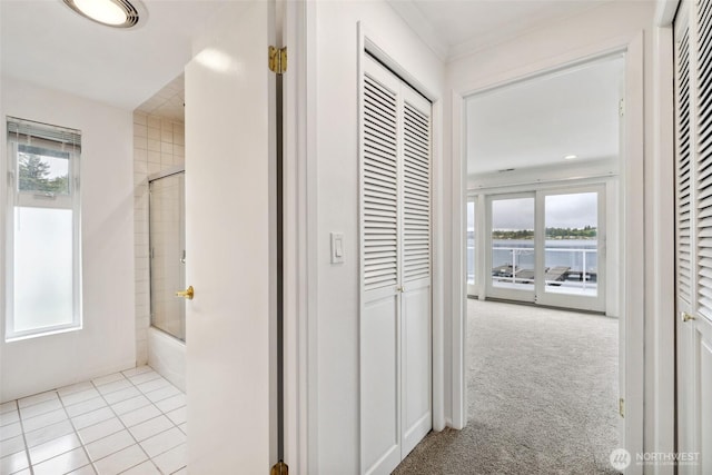 hall featuring a water view and carpet floors