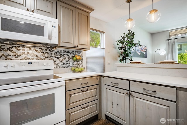 kitchen with white appliances, tasteful backsplash, healthy amount of natural light, and light countertops
