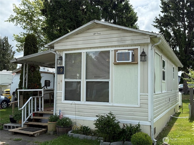 view of front of house with an AC wall unit