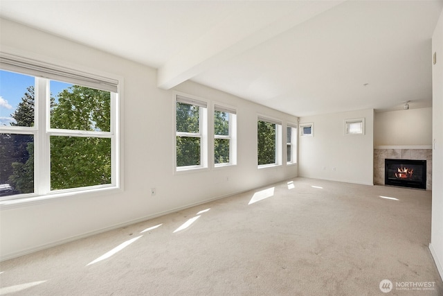 430 SW 156th St Unit 204, Burien, WA 98166 - unfurnished living room with carpet floors, a tiled fireplace, baseboards, and beamed ceiling