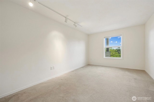 430 SW 156th St Unit 204, Burien, WA 98166 - spare room with track lighting, light carpet, and baseboards