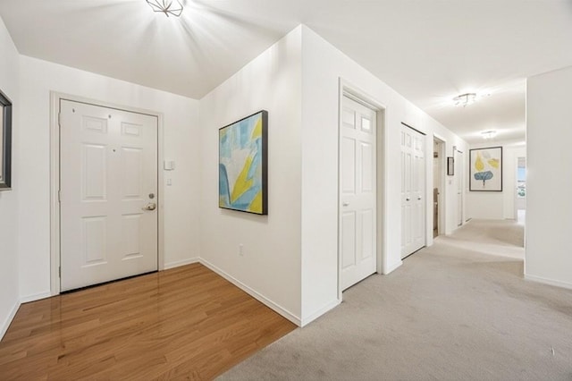 430 SW 156th St Unit 204, Burien, WA 98166 - foyer with baseboards, carpet, and wood finished floors