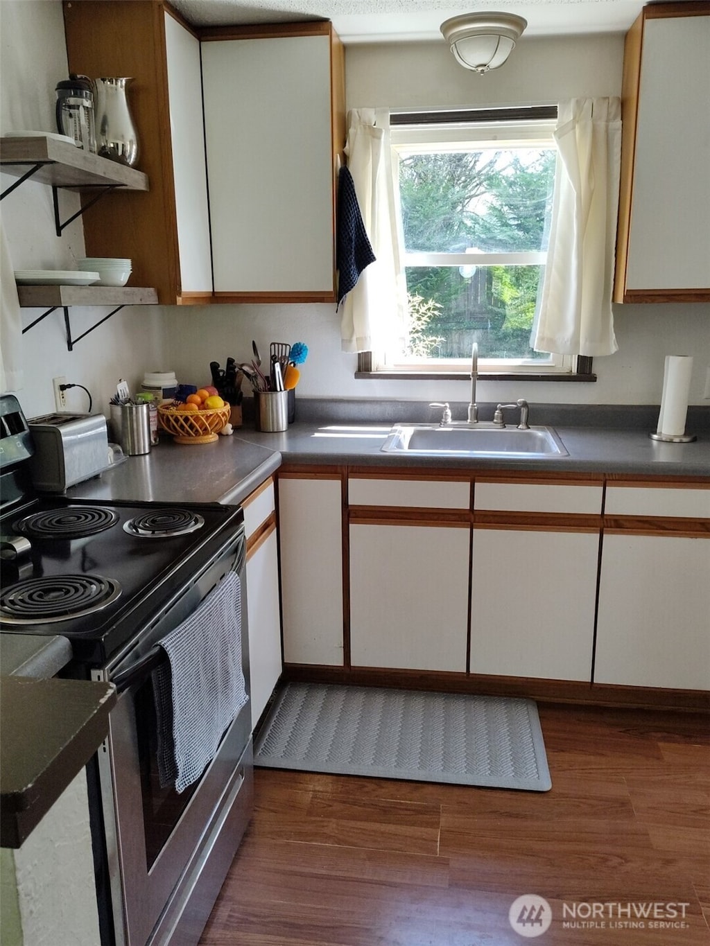 14818 5th Ave NE, Shoreline, WA 98155 - kitchen featuring electric stove, a sink, wood finished floors, open shelves, and dark countertops