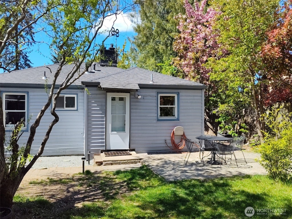 14818 5th Ave NE, Shoreline, WA 98155 - back of property with a chimney, a patio area, and roof with shingles