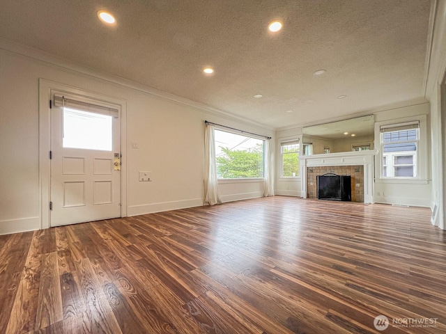1915 Dexter Ave N, Seattle, WA 98109 - unfurnished living room with crown molding, recessed lighting, a textured ceiling, baseboards, and dark wood-style floors