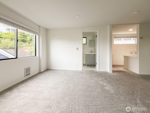 1915 Dexter Ave N, Seattle, WA 98109 - unfurnished bedroom featuring carpet floors, baseboards, recessed lighting, ensuite bathroom, and a sink