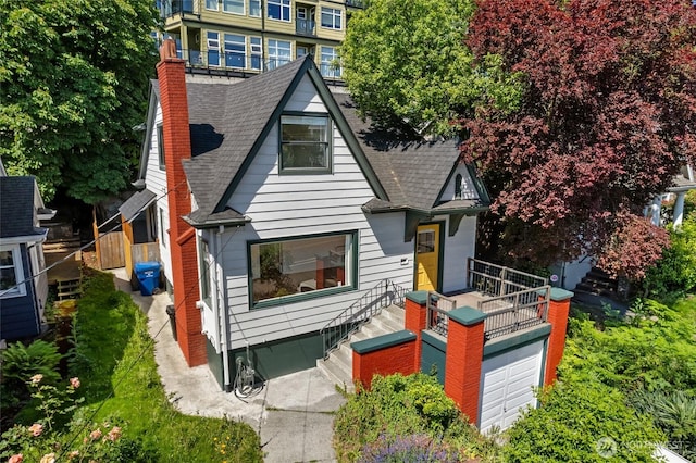 1915 Dexter Ave N, Seattle, WA 98109 - view of front facade featuring a shingled roof, a chimney, and a garage
