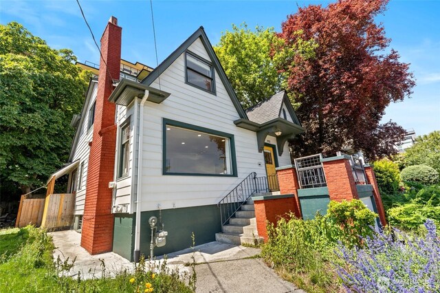 1915 Dexter Ave N, Seattle, WA 98109 - view of front of property featuring a chimney and a shingled roof