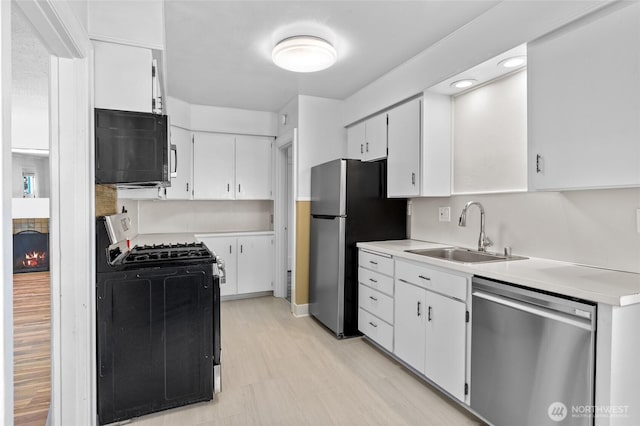 1915 Dexter Ave N, Seattle, WA 98109 - kitchen with appliances with stainless steel finishes, light countertops, white cabinetry, light floors, and recessed lighting