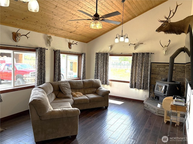 54 Jaquish Rd, Omak, WA 98841 - living area with wood ceiling, lofted ceiling, a wood stove, baseboards, and ceiling fan
