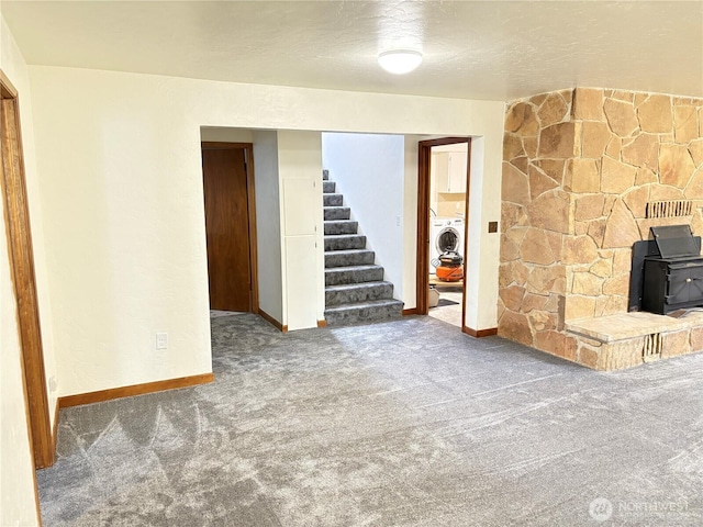 54 Jaquish Rd, Omak, WA 98841 - unfurnished living room with a wood stove, carpet floors, stairway, and baseboards