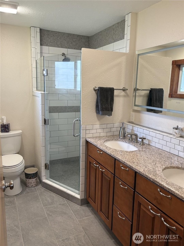 54 Jaquish Rd, Omak, WA 98841 - full bathroom with toilet, a stall shower, double vanity, and plenty of natural light