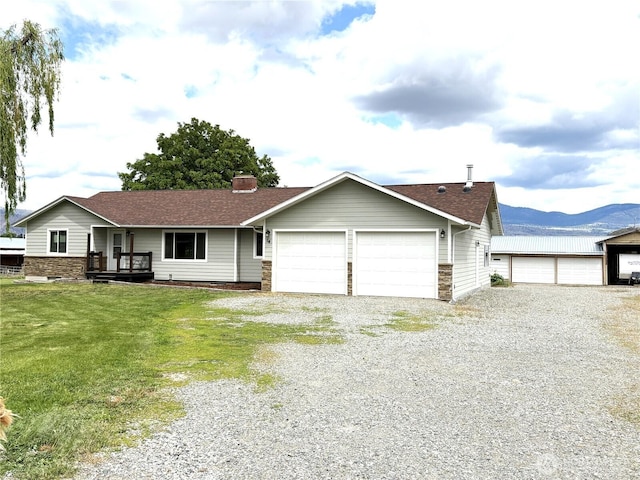 54 Jaquish Rd, Omak, WA 98841 - single story home featuring an attached garage, a front yard, a mountain view, a chimney, and driveway