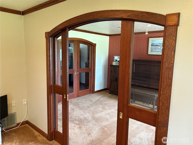 54 Jaquish Rd, Omak, WA 98841 - corridor with carpet flooring, arched walkways, crown molding, and baseboards