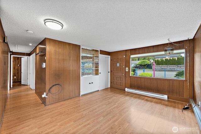1811 S Sprague Ave, Tacoma, WA 98405 - foyer entrance featuring baseboard heating, light wood-style floors, wood walls, and a textured ceiling