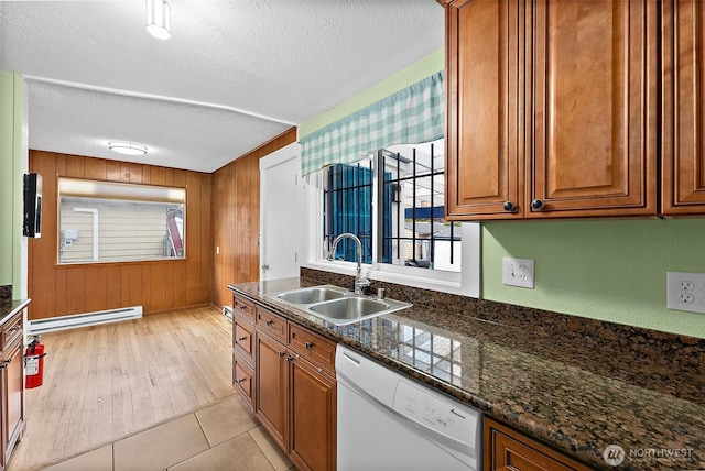 1811 S Sprague Ave, Tacoma, WA 98405 - kitchen featuring white dishwasher, a sink, baseboard heating, brown cabinets, and a textured ceiling