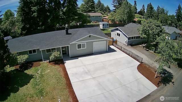 64 Queets St, Steilacoom, WA 98388 - view of front of property with concrete driveway, an attached garage, and a residential view