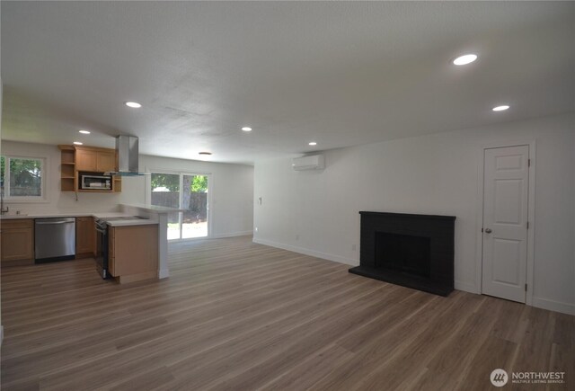 64 Queets St, Steilacoom, WA 98388 - kitchen featuring stainless steel appliances, open shelves, a wall mounted AC, island exhaust hood, and open floor plan