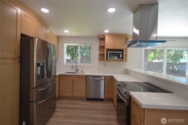 64 Queets St, Steilacoom, WA 98388 - kitchen featuring appliances with stainless steel finishes, a sink, island range hood, light wood-type flooring, and open shelves