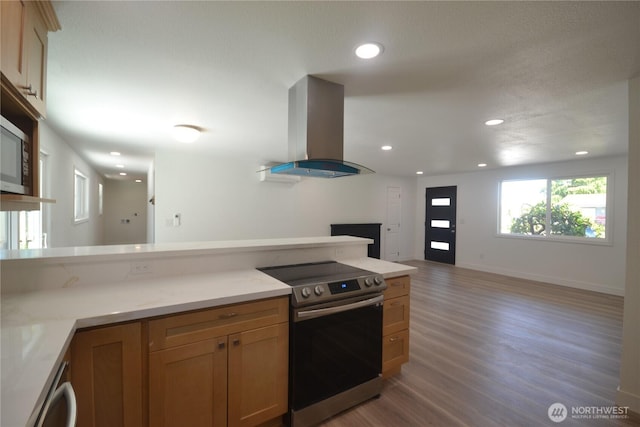 64 Queets St, Steilacoom, WA 98388 - kitchen featuring stainless steel electric stove, exhaust hood, light wood-style flooring, open floor plan, and recessed lighting