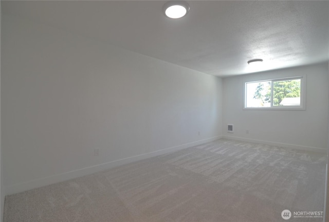 64 Queets St, Steilacoom, WA 98388 - unfurnished room featuring light carpet, baseboards, and a textured ceiling