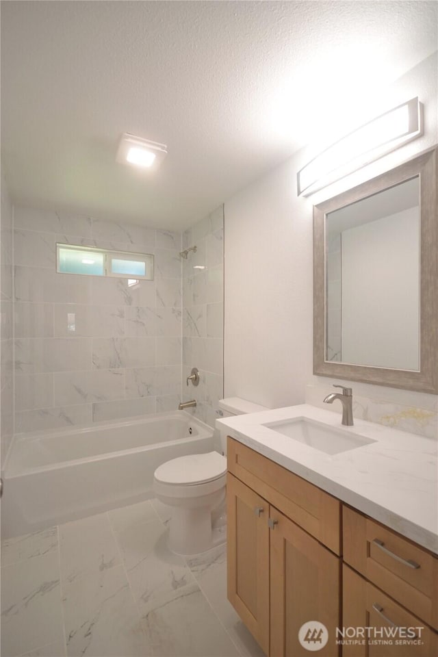 64 Queets St, Steilacoom, WA 98388 - bathroom with vanity, tub / shower combination, toilet, a textured ceiling, and marble look tiles